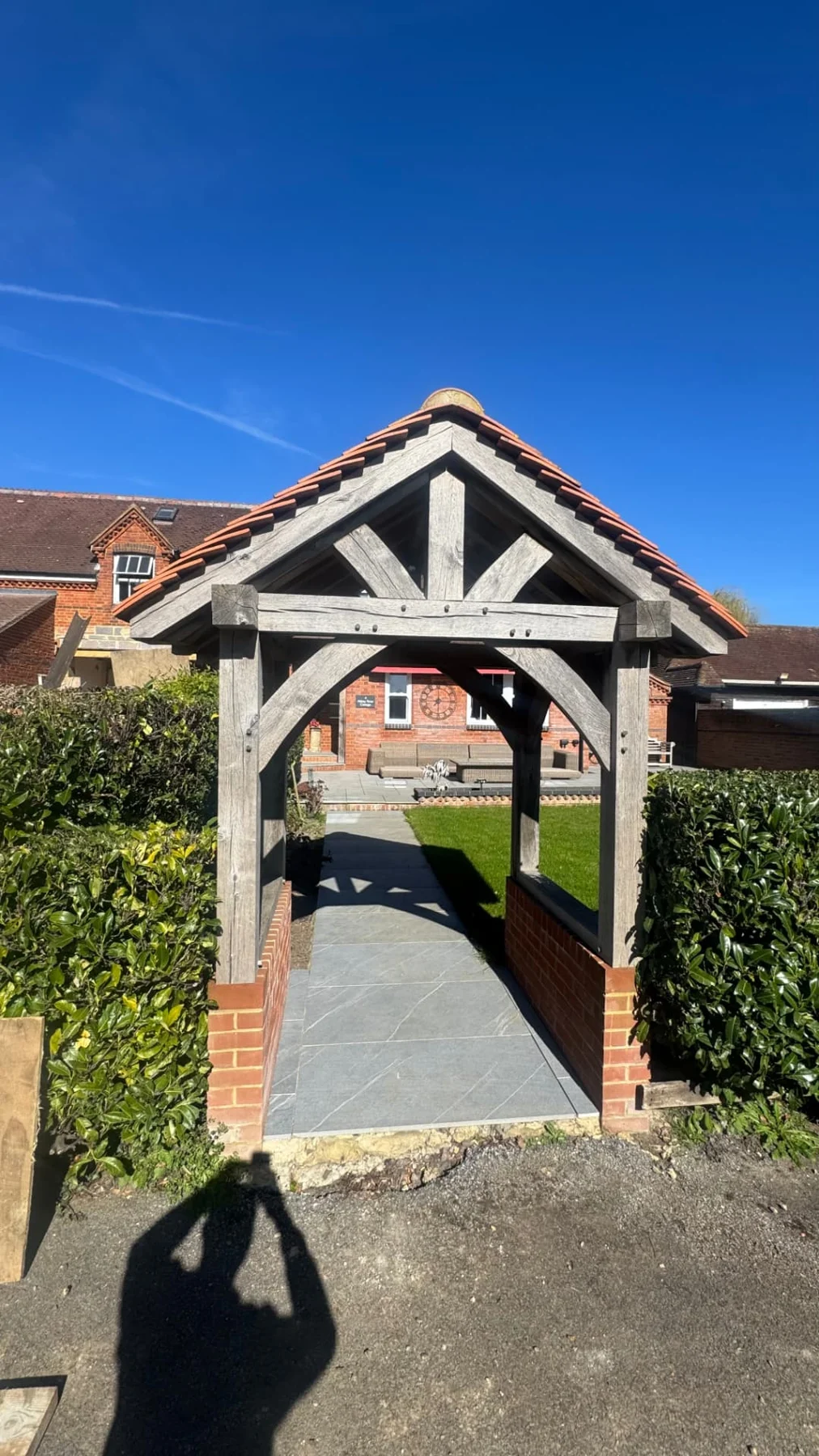 Timber-framed tiled canopy over a garden path