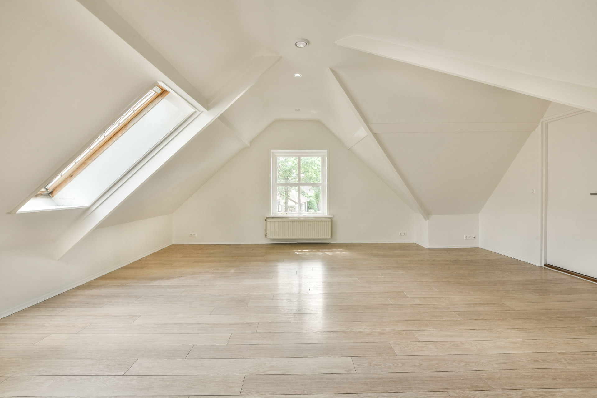 Finished loft room with sloping ceilings, roof window and timber flooring
